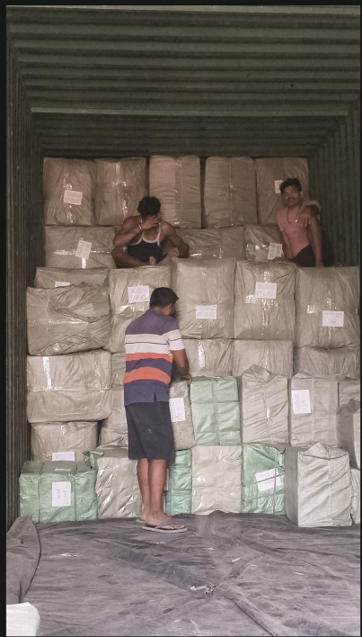 Warehouse workers loading cartons at a Bhiwandi warehouse near Mumbai
